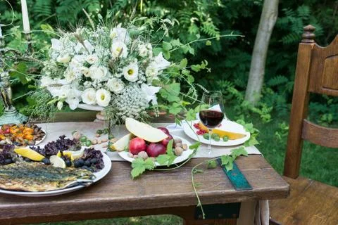 Served wedding table for dinner with delicious fruits and a glass of red wine Stock Photos