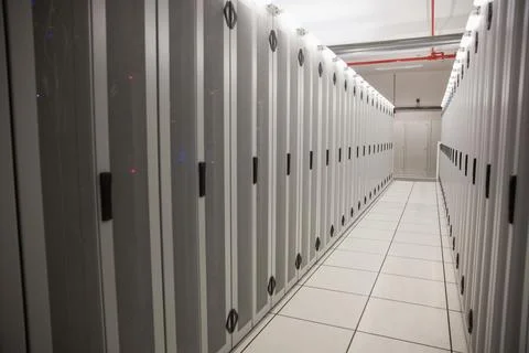 Server cabinets are receding into server room hallway in 3D render with raised Illustrazione stock