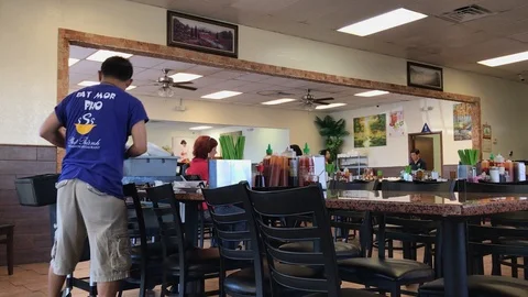 Server Clearing Table at Asian Restaurant Stock Footage 121176290