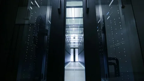 Server Engineer in Data Center Walks Through Sliding Doors Stock Footage 74621347