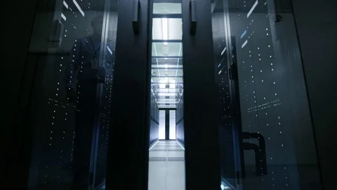 Server Engineer Walks into Opening Sliding Doors and Goes Through Data Center  Stockbeeldmateriaal 74621258