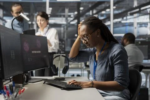 Server farm employee trying to fix compromised equipment after hacker attack Stock Photos
