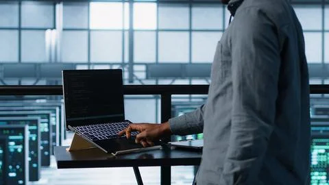 Server farm employee using artificial intelligence tech on devices 写真素材