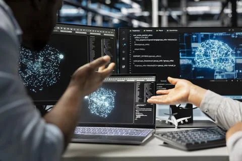Server farm engineering team looks at data analysis graph Stock Photos