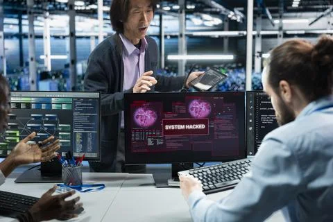 Server farm engineers seeing hacking warning, working to secure systems Stock Photos
