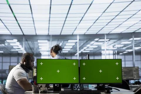 Server farm engineers use chroma key computer to monitor performance Stock Photos
