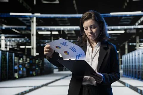 Server farm IT professional looking over maintenance diagnostic reports Stock Photos