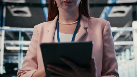 Server farm IT specialist using tablet app to do network management Stock Footage 330028819