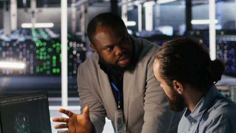 Server farm manager overseeing engineer examining neural network algorithms Stock-Footage 309616565
