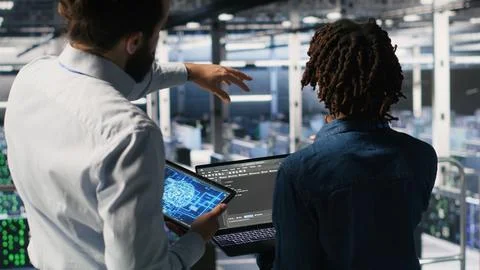 Server farm manager overseeing workers doing AI automatization Stock Photos