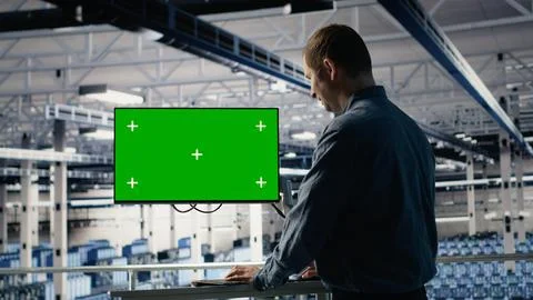 Server farm programmer using green screen computer to scan hardware rigs 写真素材