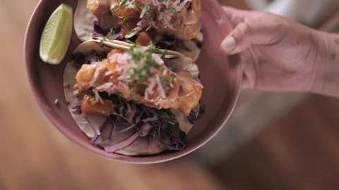 Server Holding a Plate of Colorful Garnished Fish Tacos 스톡 동영상 305022053