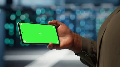 Server hub admin uses isolated screen smartphone to watch video tutorial Stock Photos