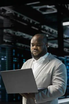 Server hub developer using laptop to fix network issues affecting storage arrays Stock Photos