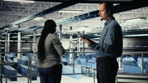 Server hub IT expert guides clients through setting up secure data backups Stock Footage 314804243