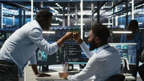Server hub manager checking AI data analytics graphs, congratulating worker 스톡 사진