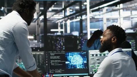 Server hub manager checking AI data analytics graphs, congratulating worker Stock Photos