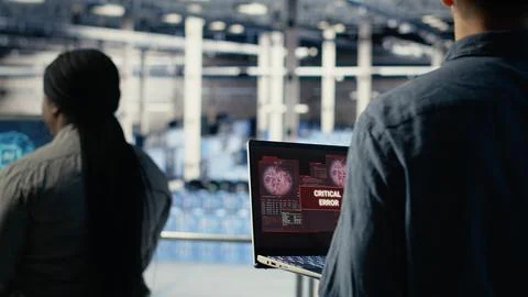 Server hub programmer alerted by warning message on laptop about bugs Stock Photos