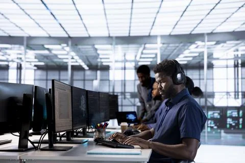 Server hub software developer listening music, debugging code Stock Photos