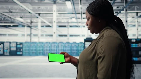 Server hub system administrator uses green screen smartphone to watch video Stock Footage 317201983