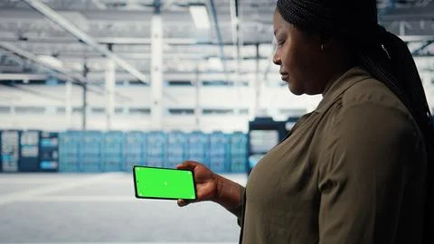 Server hub system administrator uses green screen smartphone to watch video 스톡 사진