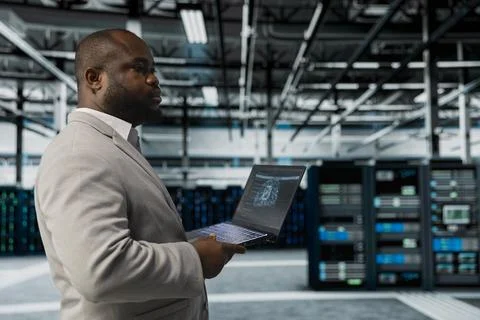 Server hub system administrator using AI software on laptop Stock Photos