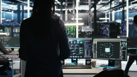 Server hub technician arriving in office, using AI visualization insights on PC Stock Footage 307039454