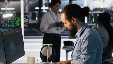 Server hub worker arranging desk objects to optimize efficiency during tasks Stock Photos