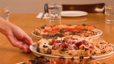 Server Placing Fresh Neapolitan Pizza on Wooden Restaurant Table Stock Footage 337769003