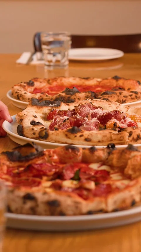 Server Placing Fresh Neapolitan Pizza on Wooden Restaurant Table Stock Footage 338041798