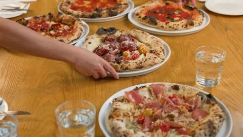 Server Placing Fresh Neapolitan Pizza on Restaurant Table Stock Footage 338051885