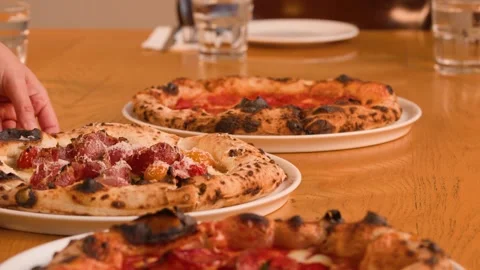 Server Placing Fresh Neapolitan Pizza on Restaurant Table Stock Footage 338052811
