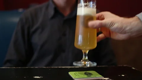 Server Placing Glass Of Beer On Table For Customer Vídeo Stock 344847942