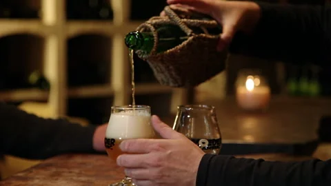 Server Pouring Craft Beer from Wicker Wrapped Bottle Tilting Handheld Shot 스톡 동영상 346765984