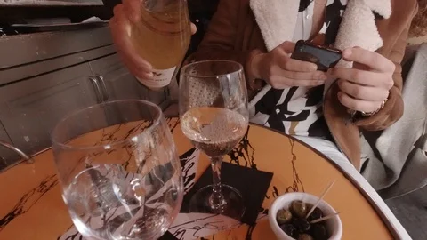 Server pouring two glass of wine in a Paris Cafe Stock Footage 126644490