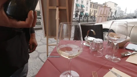 Server Pouring Two Wine Glasses in Italy Stock Footage 127329206
