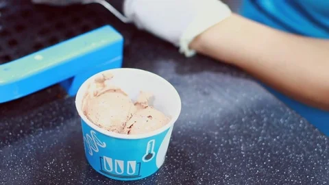 Server puts bowls of ice cream in a glass Stock Footage 75843382