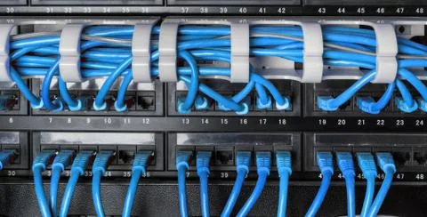 Server rack with blue internet patch cord cables Stock Photos