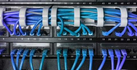 Server rack with blue internet patch cord cables Stock Photos