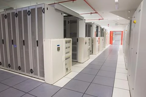 Server racks and PDUs lining 3D render data center corridor, showing tiles, fire Stock Photos