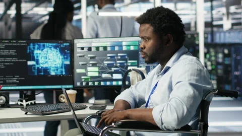 Server room admin with disability interprets machine learning generated data Stock Footage 307322253