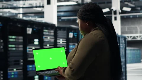 Server room admin uses green screen laptop to upgrade mainframes Stock Footage 317204809