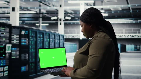 Server room admin uses green screen laptop to upgrade mainframes Stock Footage 317206877