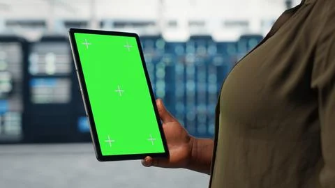 Server room admin uses isolated screen tablet to increase workload capacity Stock Photos