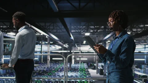 Server room admin uses tablet and headset to provide infrastructure tech support Stock Footage 310278184