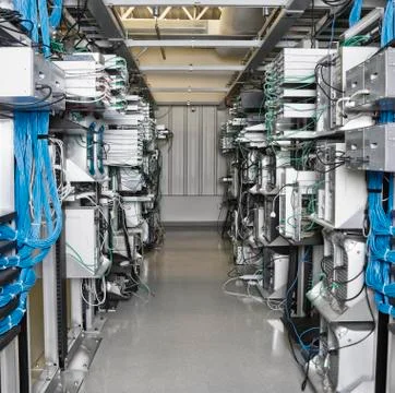 Server room aisle showing computer servers and CAT 5 cables. Stock Photos