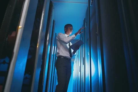 Server room, below and black man on tablet for inspection, diagnostics and Stock Photos