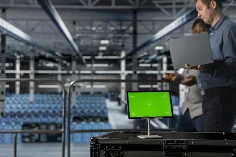 Server room colleagues managing IT infrastructure using mockup device 스톡 사진