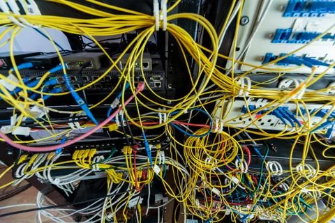 Server room with computers for internet. Network cables connected to switches. Stock Photos