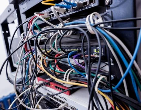 Server room with computers for internet. Network cables connected to switches. Stock Photos